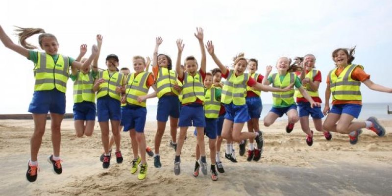 Pupils running mile-a-day take to beach to help fund new track